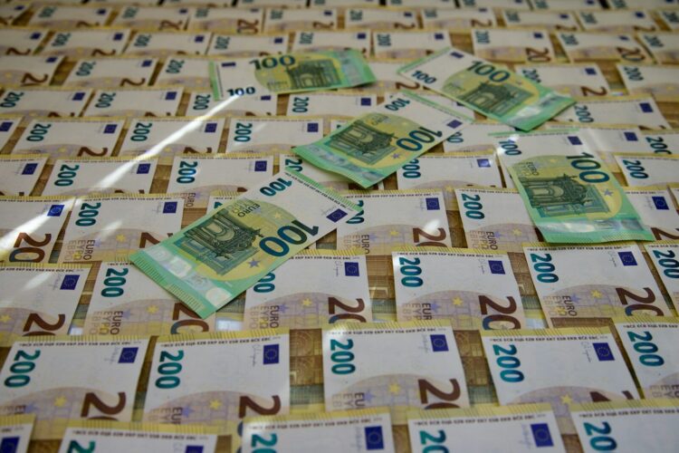 A pile of money sitting on top of a table