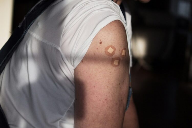 A man with a white shirt and a black backpack