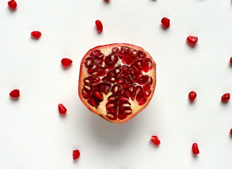 Red sliced fruit on white surface