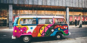 multicolored minivan parked on roadside near building