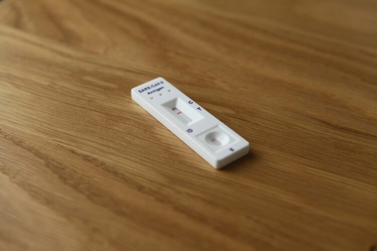 A remote control sitting on top of a wooden table