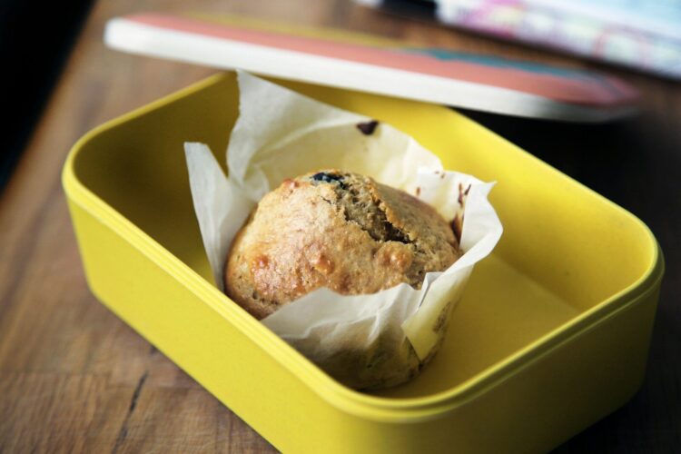 Muffin on yellow plastic container
