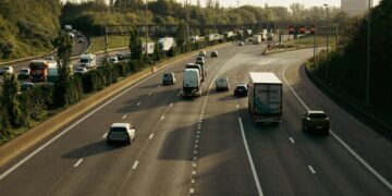 a highway filled with lots of traffic next to trees