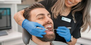 a person brushing a person's teeth