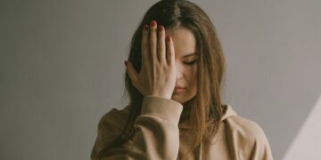 a woman covering her face with her hands