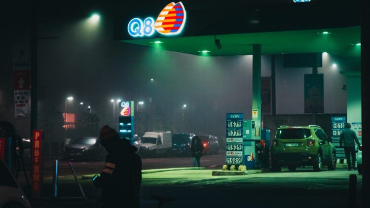 Car and people at the q8 gas station during night