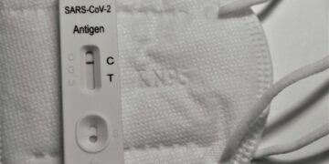 white samsung charger on white textile