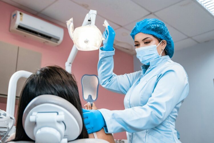 A woman getting her teeth checked by a dentist
