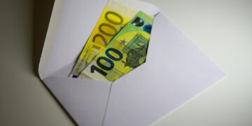 a white envelope with money sticking out of it