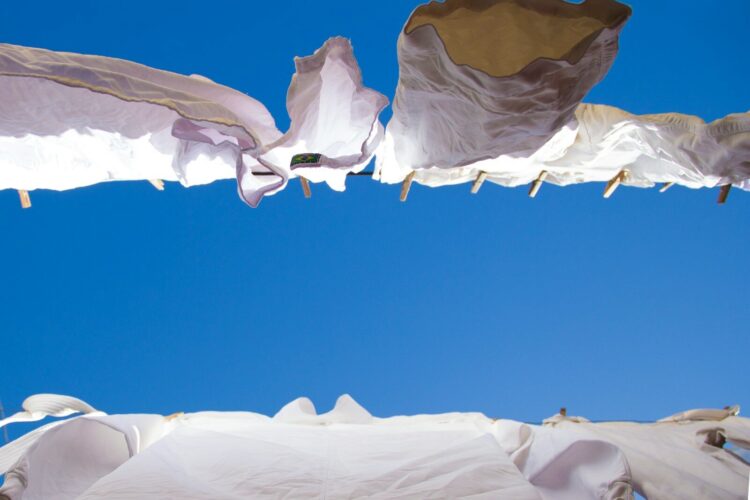 Hanged white clothes under blue sky