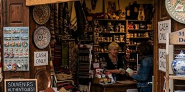 Souvenir shop with baskets of spices at the front and a large 'Cash Only' sign above the doorway.