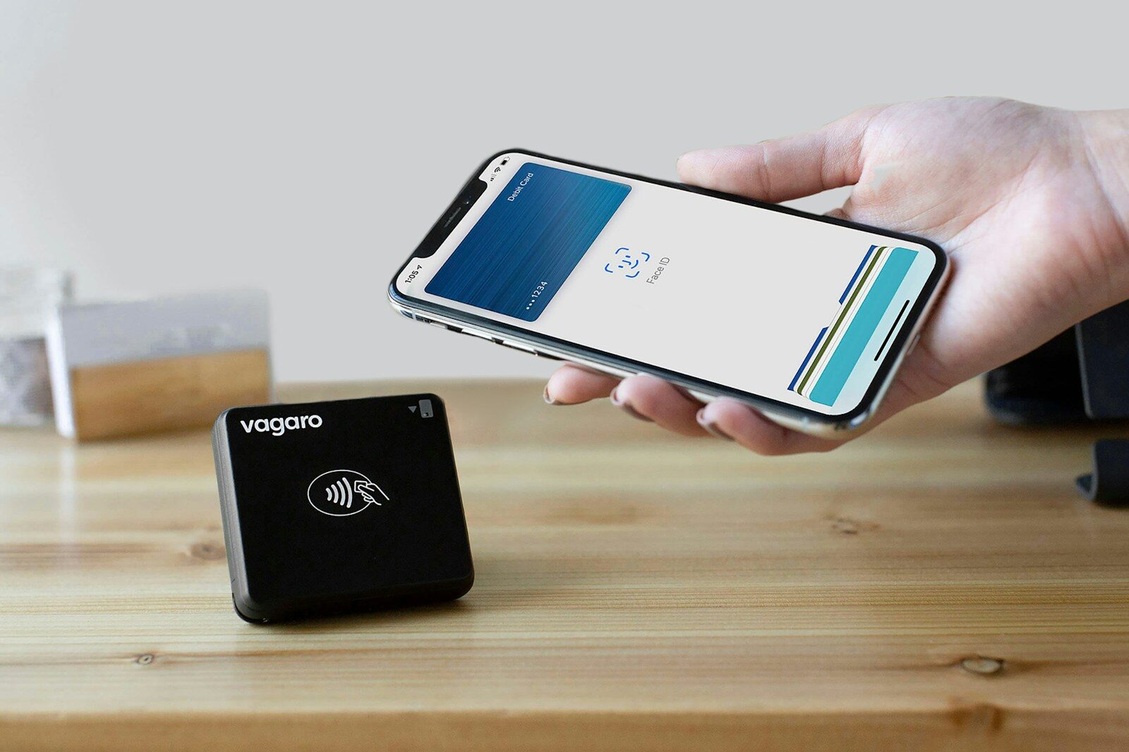 A person holding a cell phone next to a charger