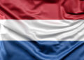 Waving flag of the netherlands with horizontal red white and blue stripes on fabric