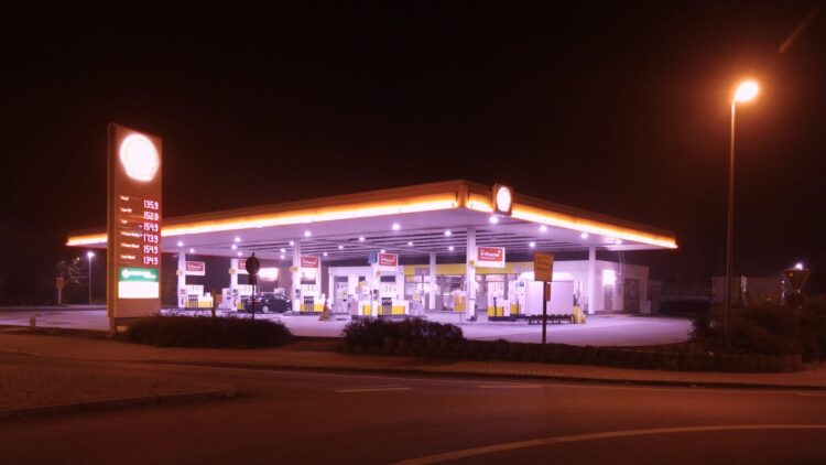 Gas station illuminated at night with glowing lights