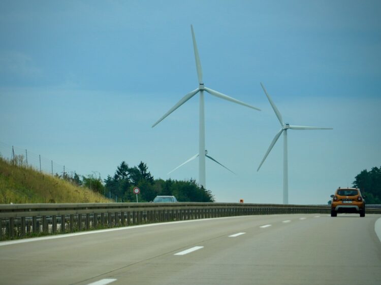 White wind turbines on green grass field during daytime