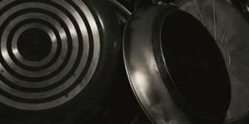 A black and white photo of pots and pans