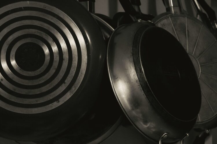 A black and white photo of pots and pans