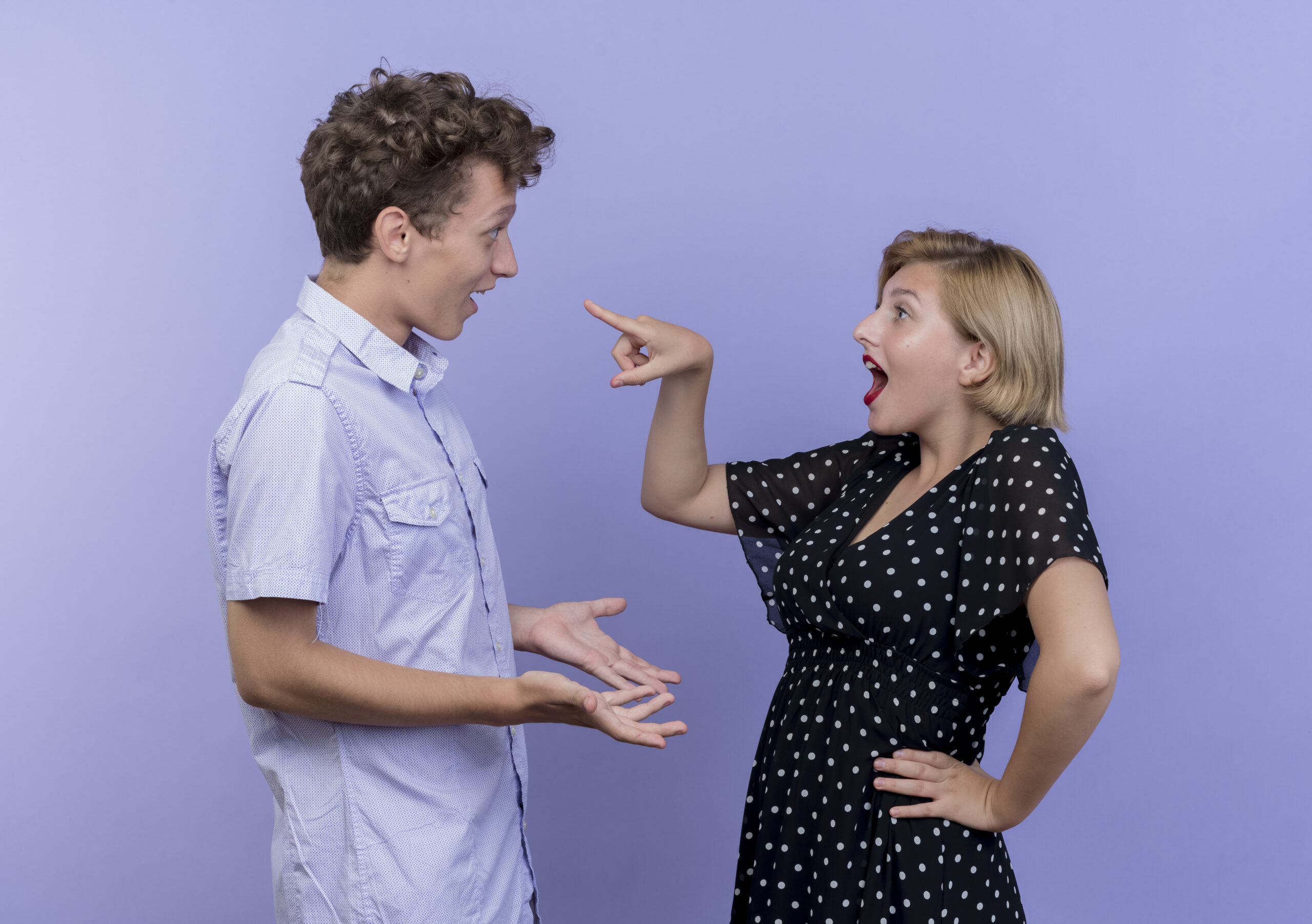 Two people facing each other with open hands appearing to argue or discuss against a purple background