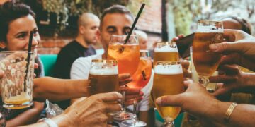 people holding drinks during day
