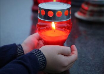 stop adult suicide, candle in child hands, left alone, emotional trauma, traumatic, condolence, mourning, sadness, remembering, grave, cemetery, outdoor