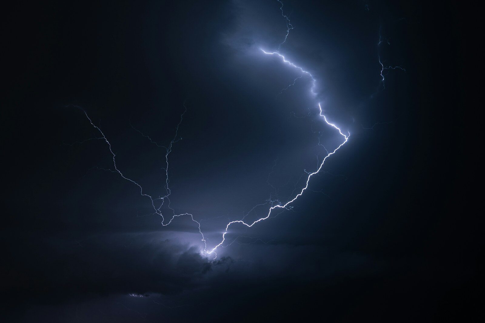 Lightning streaks across the dark sky.