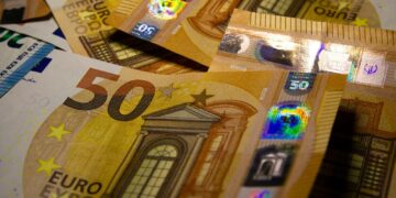 a pile of 50 euro bills sitting on top of each other