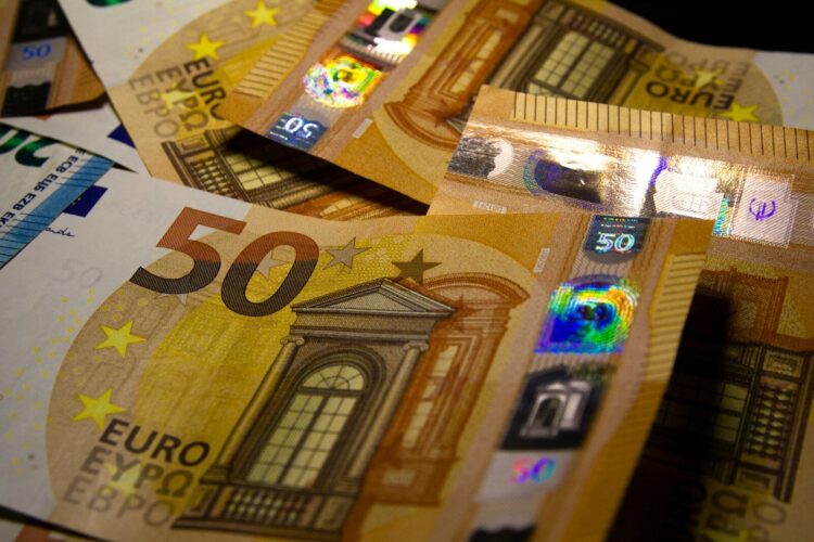 a pile of 50 euro bills sitting on top of each other