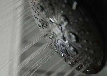 a close up of a shower head in a bathroom