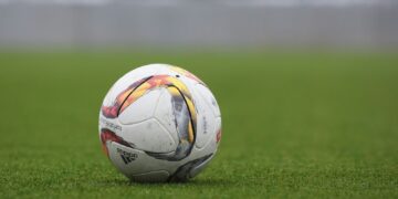 white and gray Adidas soccerball on lawn grass