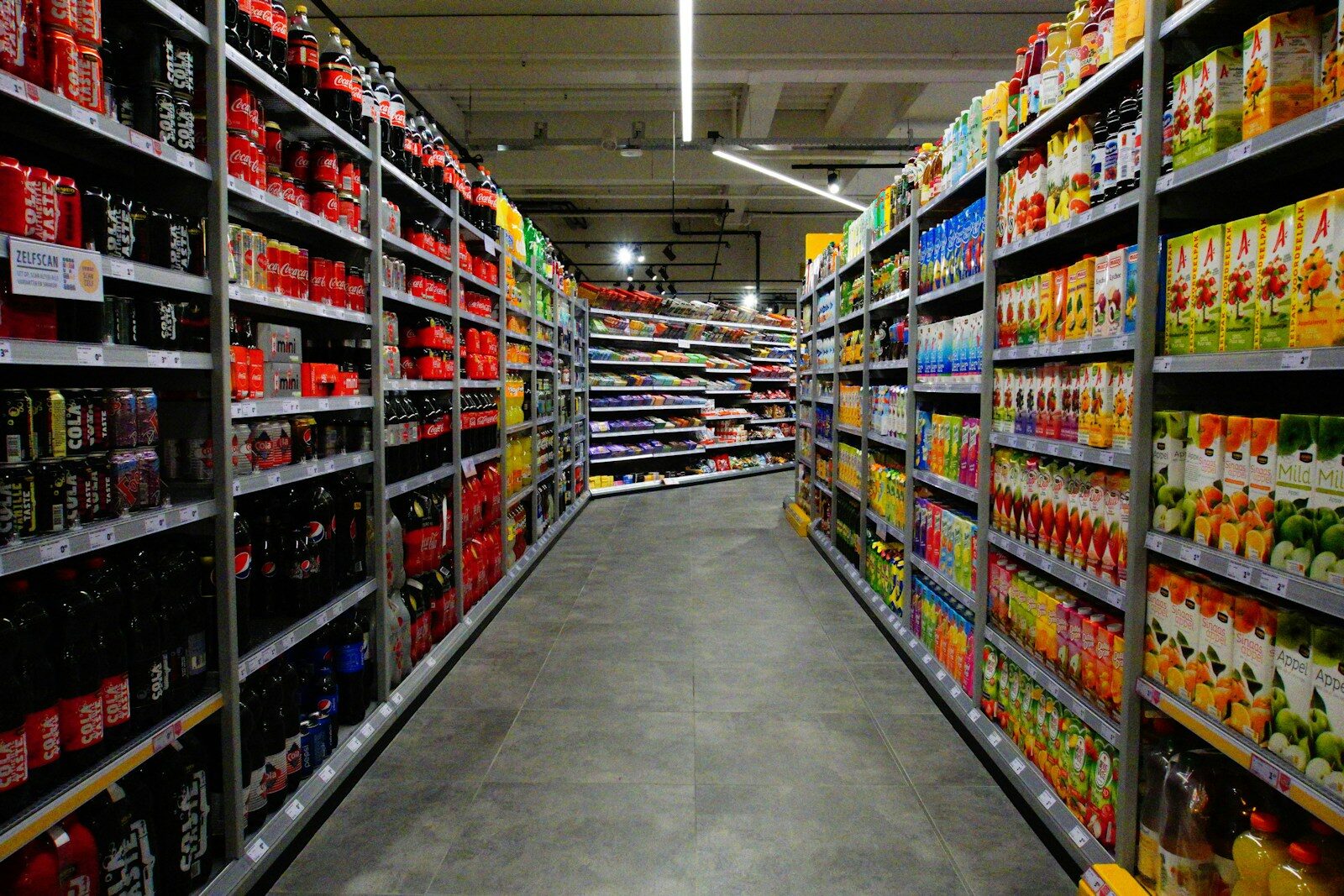 red and white labeled bottle on shelf