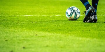 man playing soccer game on field