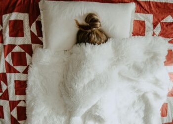 white fur textile on red and white textile
