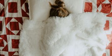 white fur textile on red and white textile