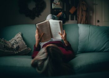 woman in red shirt reading book