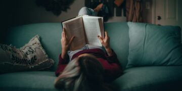 woman in red shirt reading book