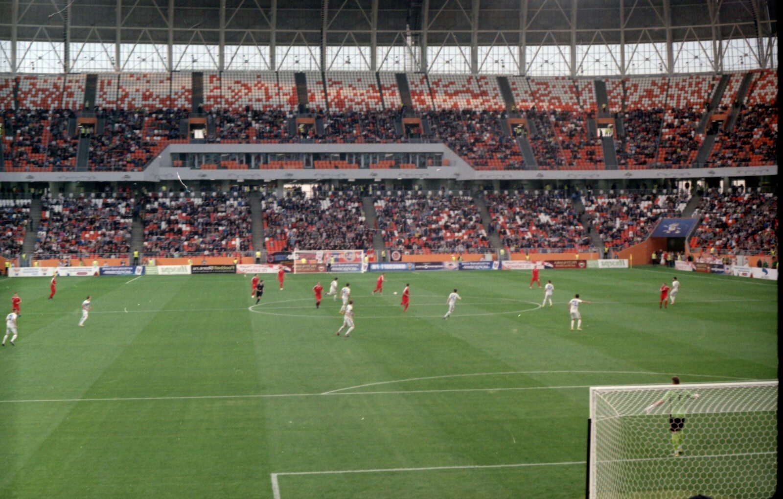 people playing soccer on field during daytime