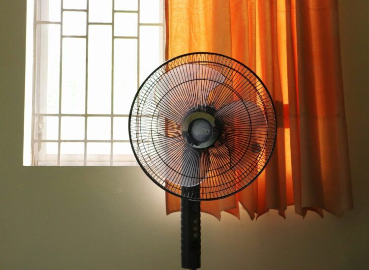 a fan in front of a window