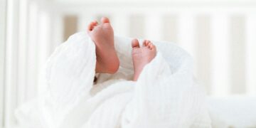 person covered with white blanket